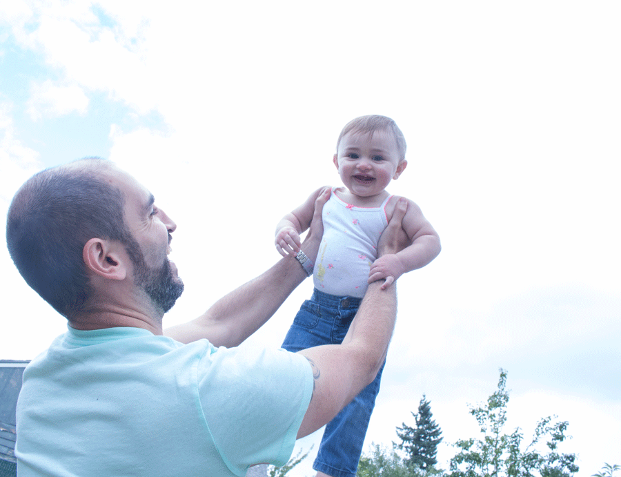 daddy-holding-baby-covered-in-cake-above-head